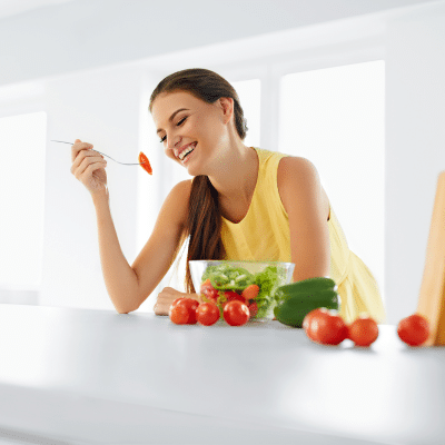 Woman eating healthy diet foods at a kitchen bar