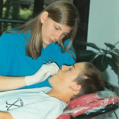 Dr. Meredith Parks working on a patient's teeth years ago, representing Parks Orthodontics