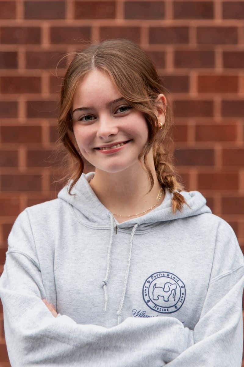 Abby smiling in a grey sweatshirt at Parks Orthodontics
