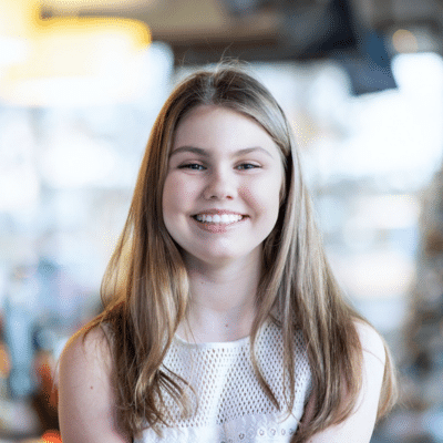 Teenage female patient at Parks Orthodontics smiling, representing how Invisalign saves money